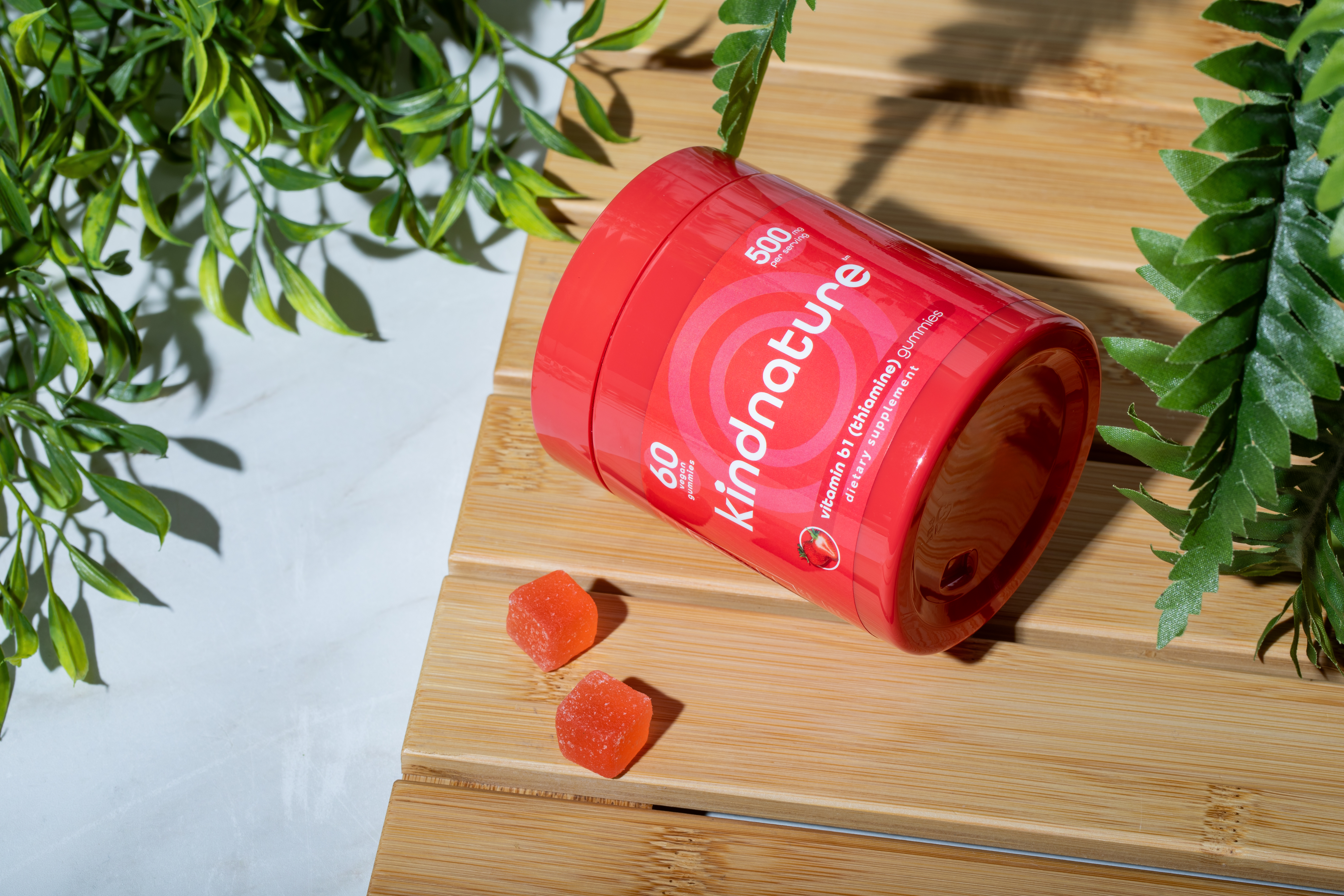 KINDNATURE B1 Thiamine gummies bottle on wooden surface with plants